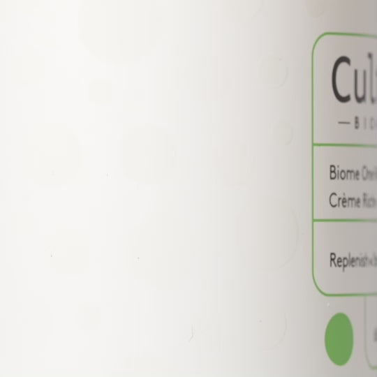 A close up video of bottle of Cultured Biome One Rich Cream showing its yellow buttery texture cream content.