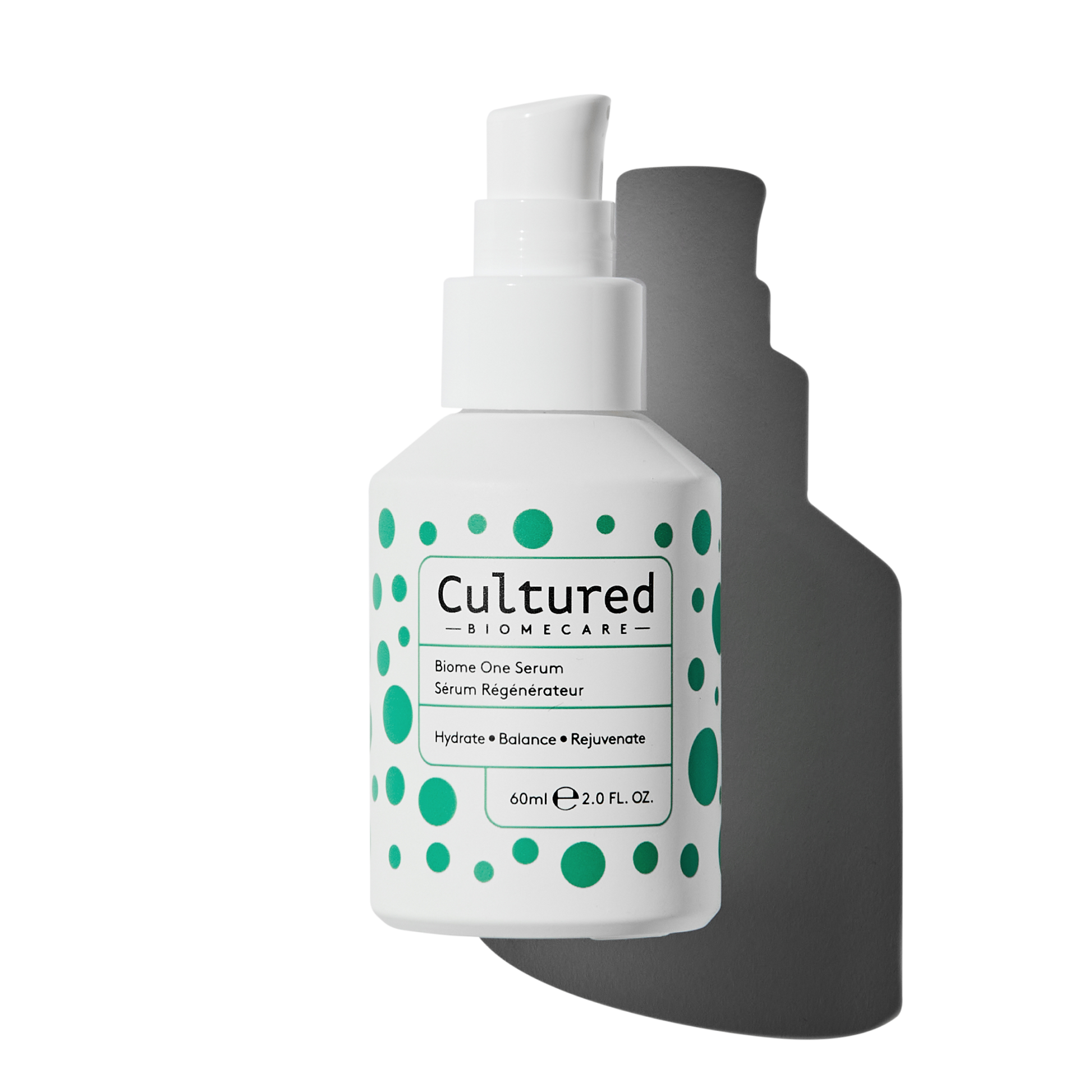 The white Biome One Serum bottle has a pump and features green spots in an assortment of sizes.