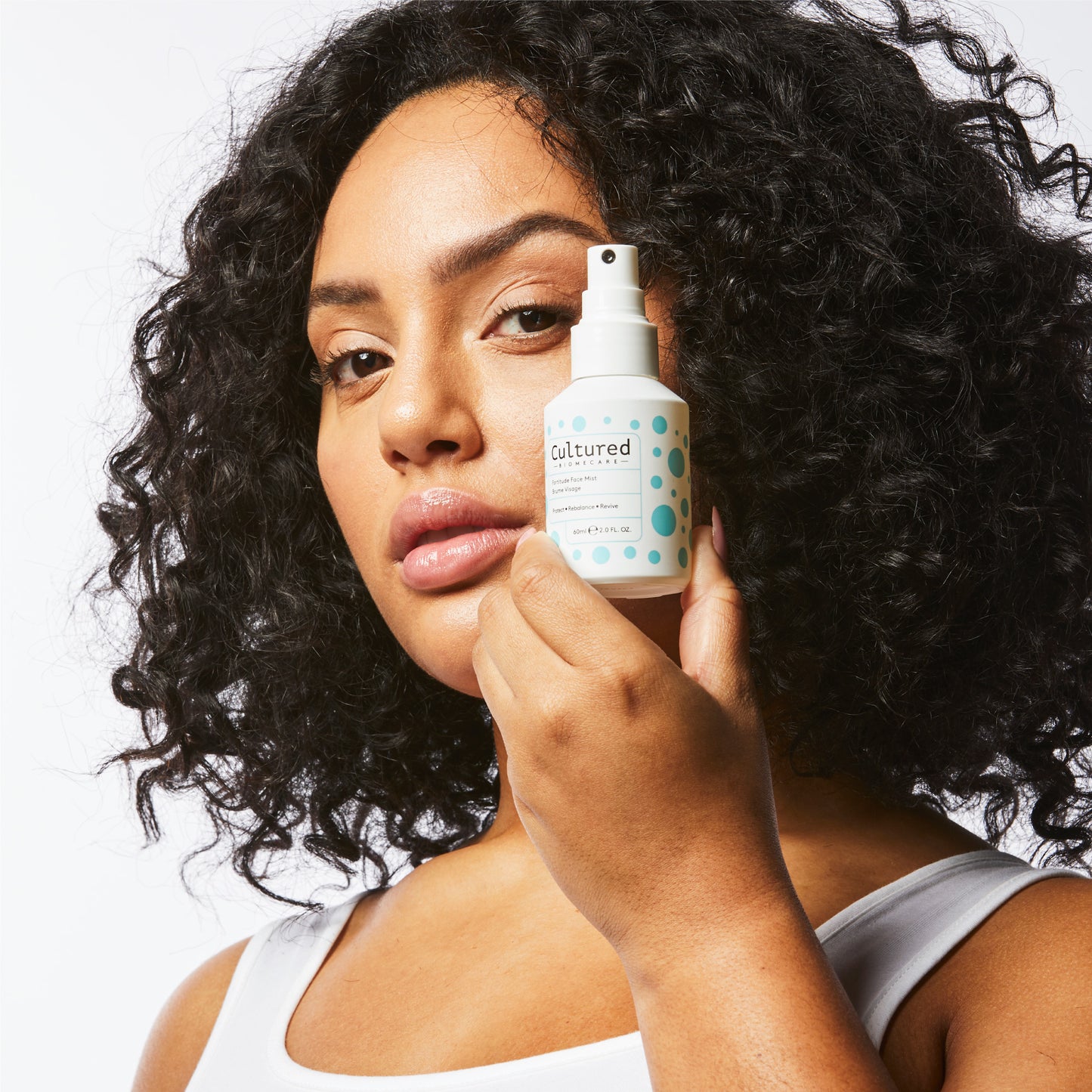 A women holds a bottle of the face mask